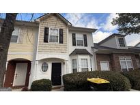 Two-story townhome with neutral siding and landscaping at 1768 Glen View Way, Hampton, GA 30228