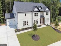 Elegant home boasts a well-manicured lawn and a spacious three-car garage at 3920 Clifton Hill Ct, Cumming, GA 30040