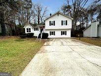 Two-story house with a large driveway and basketball hoop at 4050 Sumit Wood Dr, Kennesaw, GA 30152