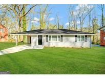 Single-story home with a lush green lawn and covered entrance at 1581 Mcclelland Ave, Atlanta, GA 30344