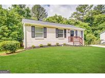 Charming single-story home with a lush green lawn and mature trees at 2843 Marco Nw Dr, Atlanta, GA 30318