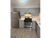 Updated kitchen with stainless steel appliances and gray cabinets at 2033 Oak Park Ln, Decatur, GA 30032