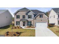 Charming two-story home with a brick and shingle exterior, front yard landscaping, and attached two-car garage at 1723 Goodwin, Hampton, GA 30228