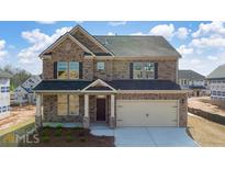 New construction home with a two-car garage and a covered front porch at 655 Edgar St, Hampton, GA 30228