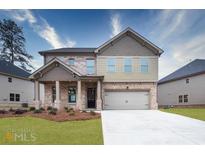 Attractive two-story home with a brick and siding exterior, front porch, and attached two-car garage at 659 Edgar St, Hampton, GA 30228