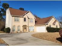 Two story house with attached garage and landscaping at 98 Gleneagles Dr, Fayetteville, GA 30215