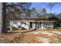 Ranch style home with mature trees and a spacious yard at 1471 Cedar Creek Ln, Riverdale, GA 30296