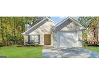 Charming one-story house with attached garage and well-manicured lawn at 1641 Ne Riverchase Ln, Conyers, GA 30013