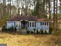 Ranch style home with a small front yard and mature trees at 5130 Highpoint Rd, Union City, GA 30291