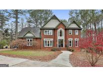 Brick two-story house with a large front yard and walkway at 803 Natchez Ct, Peachtree City, GA 30269
