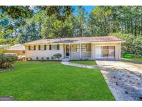 Ranch style home with carport and well-manicured lawn at 2749 Williamsburg Dr, Decatur, GA 30034