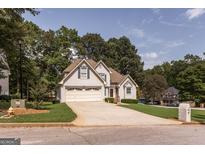 Two-story house with attached garage and manicured lawn at 75 Dunning Keep, Covington, GA 30016