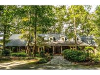 Brick home with large covered porch and stone walkway at 183 Madden Rd, Bowdon, GA 30108