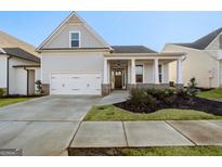 Craftsman style home with front porch and two-car garage at 613 Cork St, Woodstock, GA 30188