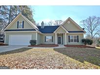 Two-story house with green siding, a white garage door, and a well-maintained lawn at 33 Ball St, Moreland, GA 30259