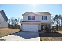 Two-story house with stone accents and a two-car garage at 552 Moline Way, Locust Grove, GA 30248