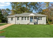 Newly renovated gray house with a green lawn and driveway at 2089 Meador Se Ave, Atlanta, GA 30315