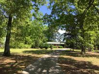 Ranch home with tree-lined driveway and spacious yard at 1623 Highway 54 W, Fayetteville, GA 30214