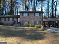 Brick house with attached carport and landscaping at 4520 Clement Sw Dr, Atlanta, GA 30331