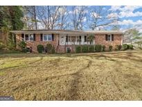 Brick ranch house with front yard and landscaping at 3330 Sw Pamlico Dr, Atlanta, GA 30331
