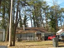 Charming one-story house with a white picket fence at 2991 Sylvan Rd, East Point, GA 30344