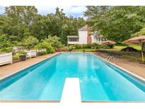 Inviting rectangular pool with diving board and patio furniture at 2398 Maddox Rd, Buford, GA 30519