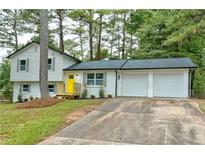 Newly renovated house with a two-car garage and a yellow door at 2592 Candler Woods Dr, Decatur, GA 30032