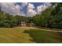 Ranch house exterior on a spacious lot with lush green landscaping at 1920 Rock House Rd, Lithia Springs, GA 30122