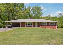 Brick ranch house with attached carport and large grassy yard at 2279 Highway 92, Acworth, GA 30102