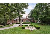 Large brick house with landscaped lawn and circular driveway at 4665 Riverview Rd, Atlanta, GA 30327