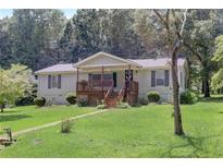 Ranch home with a covered porch and well-manicured lawn at 543 Patillo Rd, Stockbridge, GA 30281