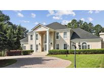 Two-story home with columns, lush landscaping, and a paved driveway at 721 Club S Ln, Marietta, GA 30067