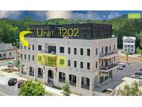 Brick building, unit 1202 highlighted, offers modern design and city views at 8212 Main St # 1202, Woodstock, GA 30188