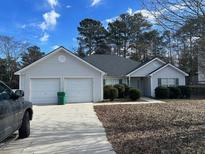 Two-car garage and a well-maintained lawn at 2372 Benson Rdg, Lithonia, GA 30058