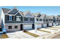 Row of new townhomes with driveways at 11719 Chatham Dr, Hampton, GA 30228