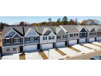 Row of new townhouses with attached garages at 11682 Chatham Dr, Hampton, GA 30228