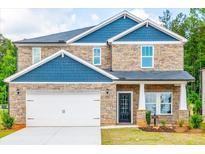 Two-story home with blue siding and stone accents at 7771 Richmond Trl, Fairburn, GA 30213