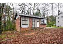 Brick ranch home with a landscaped yard and driveway at 340 Sir Richard Ct, Jonesboro, GA 30236