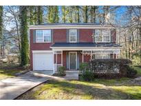 Brick home with attached garage and landscaping at 6674 Eastbriar Dr, Lithonia, GA 30058
