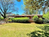 Brick ranch house with landscaped yard at 650 Lyric Nw Way, Atlanta, GA 30318