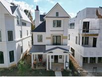 Two-story white home with gray roof, front porch, and landscaping at 11536 Serenbe Ln, Chattahoochee Hills, GA 30268