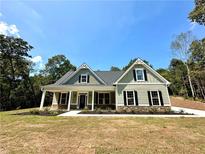 Two-story house with gray siding and a front porch at 22 Stratford Way, Kingston, GA 30145