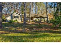 Charming two-story home nestled among trees on a landscaped lot at 1959 Grand Prix Ne Dr, Atlanta, GA 30345