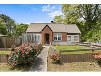 Charming ranch home with brick exterior, landscaped yard, and walkway at 3813 Stonewall Tell Rd, South Fulton, GA 30349
