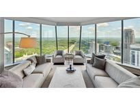 Luxury living room with floor-to-ceiling windows and city views at 3344 Peachtree Ne Rd # 3902, Atlanta, GA 30326