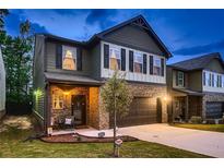 Two story home with brick and siding, two car garage at 167 Magnaview Dr, Mcdonough, GA 30253