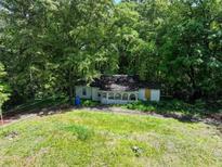 Aerial view of a house needing renovation, surrounded by lush woods at 731 Bolton Nw Rd, Atlanta, GA 30331