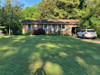 Brick ranch house with a neatly landscaped front yard at 1433 Woodland Sw Ter, Atlanta, GA 30311