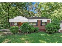 Brick ranch home with a well-maintained lawn at 2576 Godfrey Nw Dr, Atlanta, GA 30318
