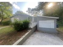 Gray brick ranch house with a small front yard at 366 Hamilton E Holmes Nw Dr, Atlanta, GA 30318